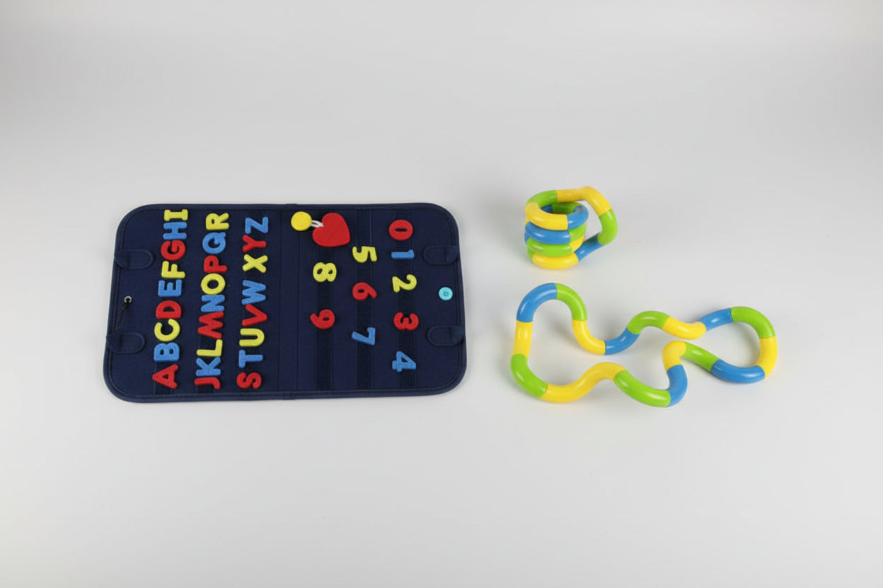 Colorful educational toys including a textured mat with letters and numbers, and two interlocking ring toys.