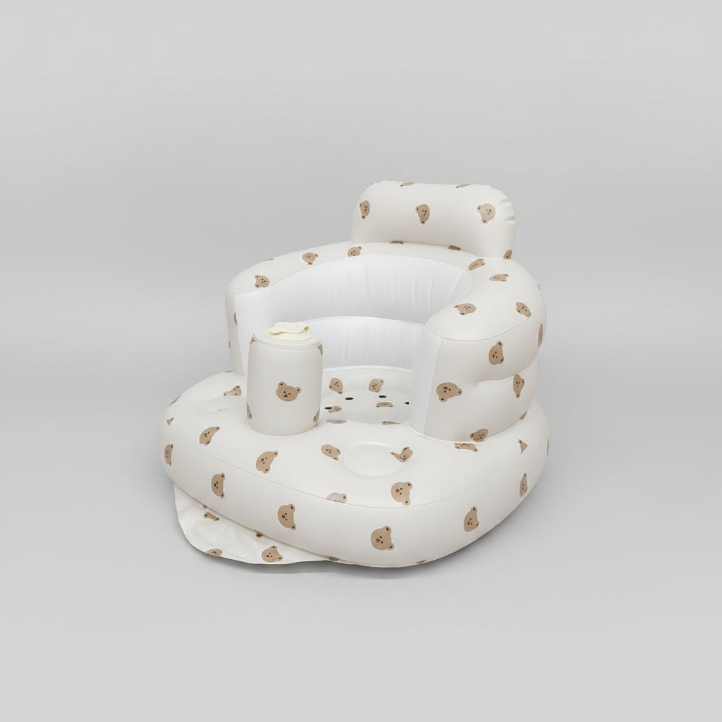 White inflatable baby seat with bear pattern on a white background