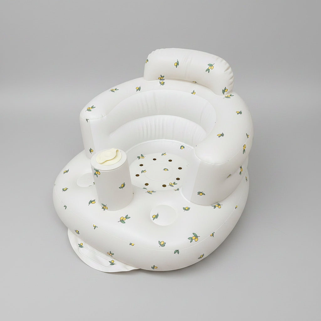 White inflatable baby seat with floral patterns on a white background