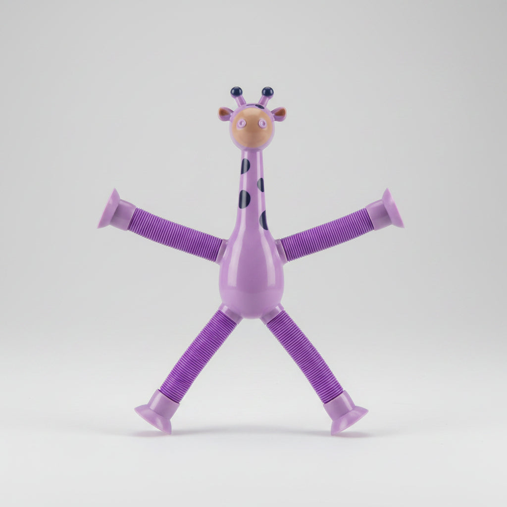 Purple giraffe-shaped toy held in a hand with a cardboard box of similar toys in the background.