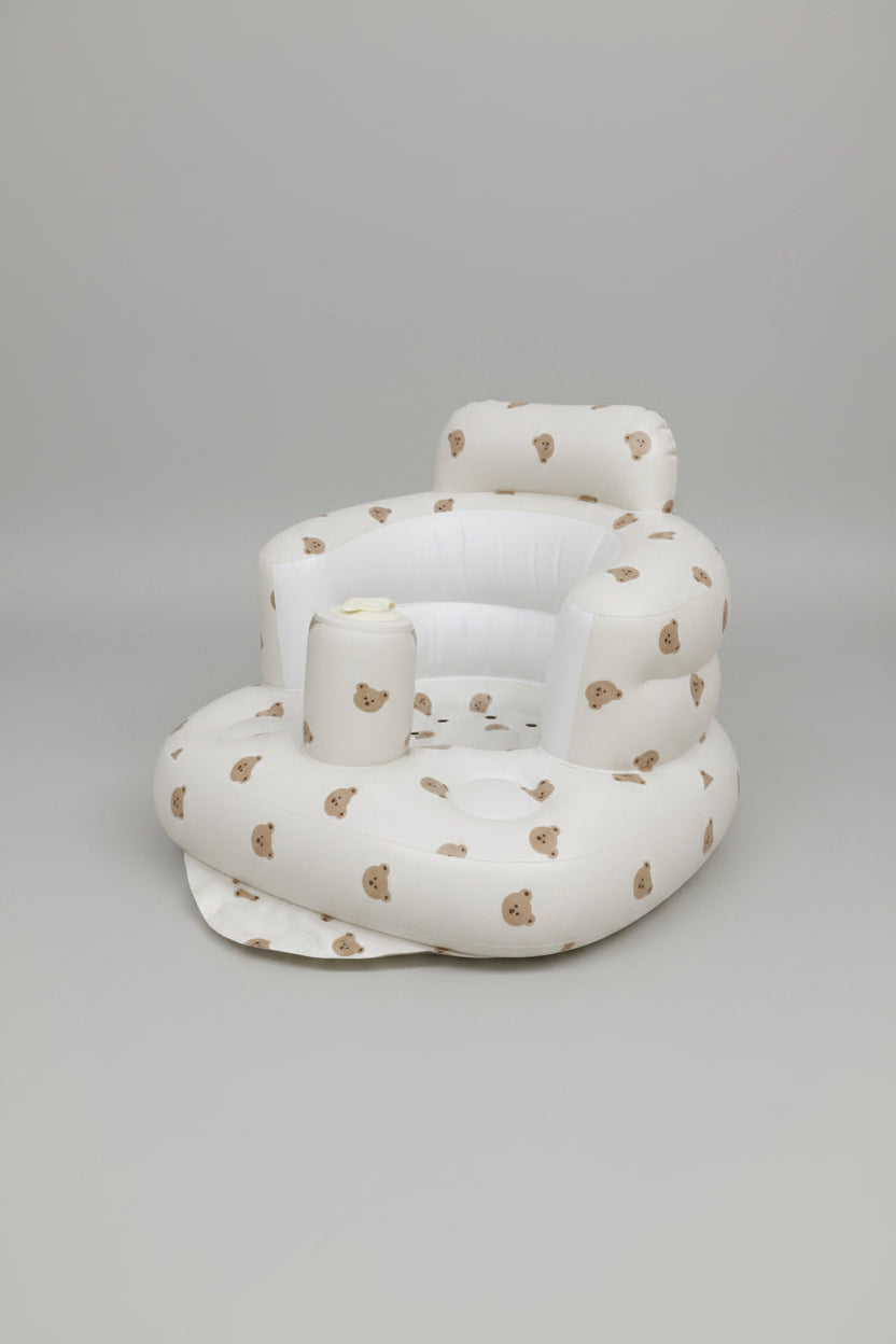 White inflatable baby seat with brown bear patterns on a white background