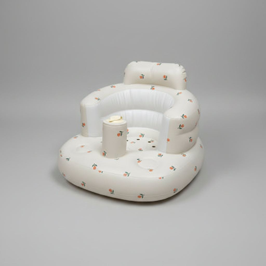 Inflatable baby seat with floral pattern on a white surface
