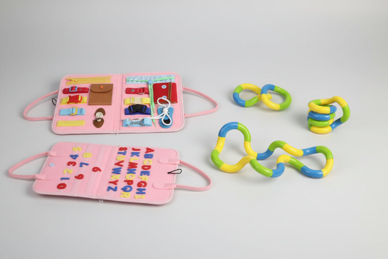 Two educational toys: a pink book with letters and numbers, and colorful interlocking rings.